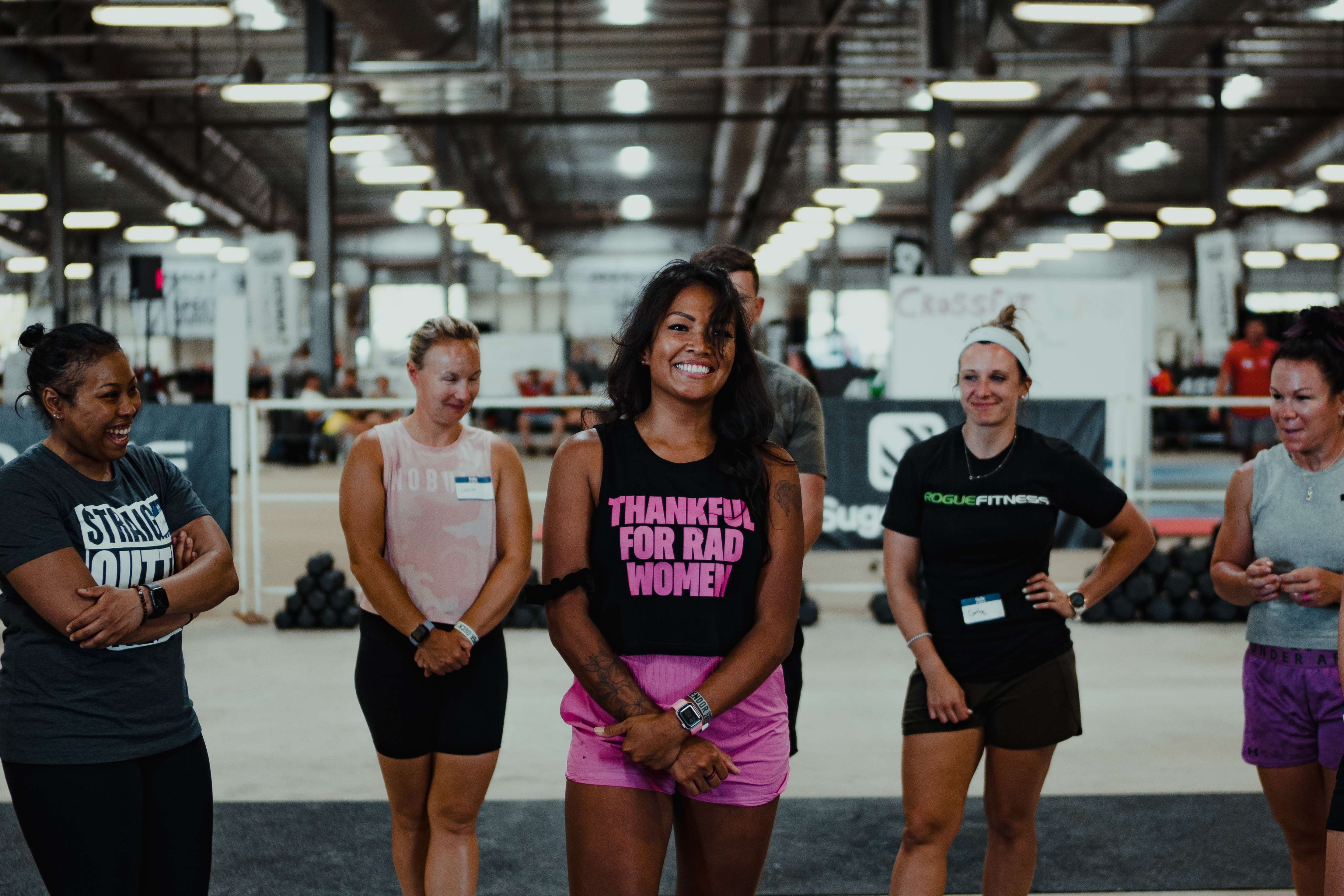 Group of women at a gym event wearing Barbells for Boobs apparel
